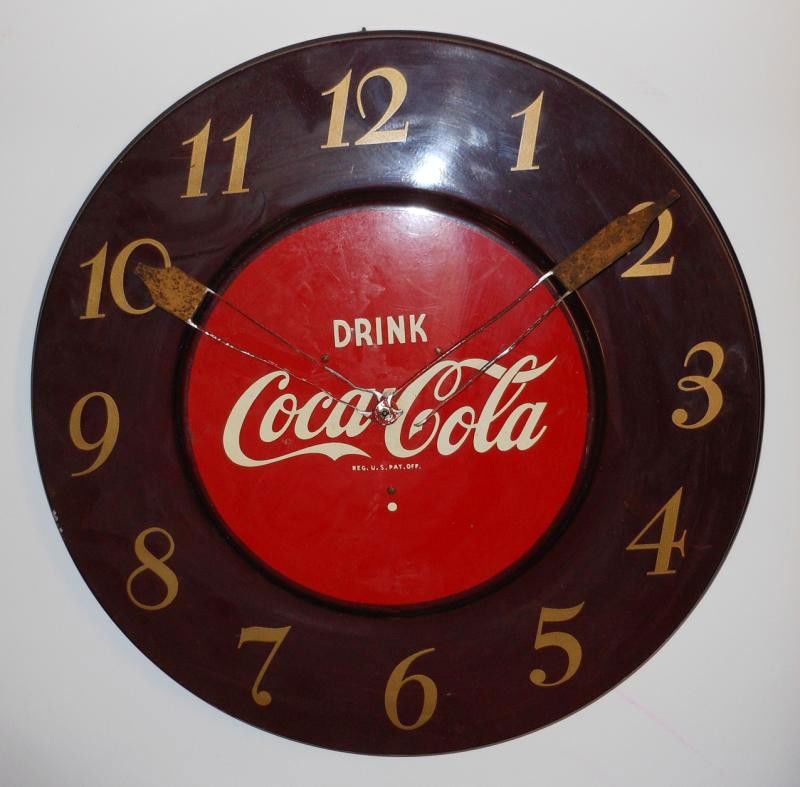 COCA-COLA 1951 CIRCULAR METAL WALL CLOCK: Maroon with gold stylized numbers, red center with "DRINK COCA-COLA", hands rough, no power, 17 3/4 in. diameter.