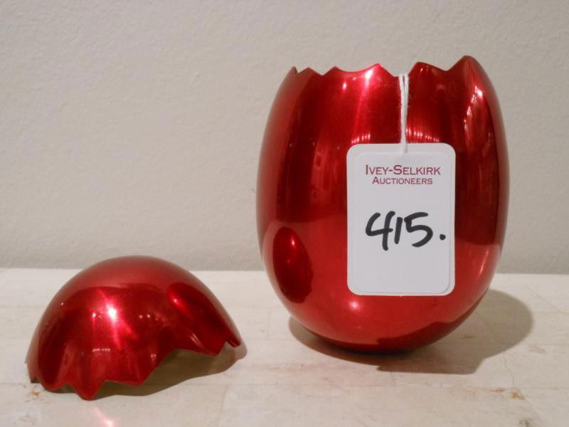 JEFF KOONS, AMERICAN (B. 1955): CRACKED EGG, RED, 1980, red enamel on anodized aluminum. 4 x 3 inches This was an invitation to the opening gala at the los Angeles Contemporary Museum of Art.