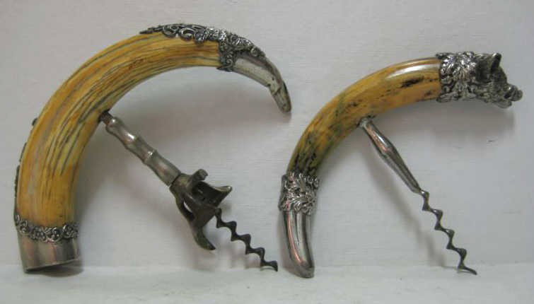 WEBSTER COMPANY, NORTH ATTLEBORO, MA: Two sterling silver mounted horn corkscrews, one with boar head and inset ruby eyes bearing Webster mark, the other chased floral marked STERLING only, late 19th century. Lengths: 6 3/4 in;