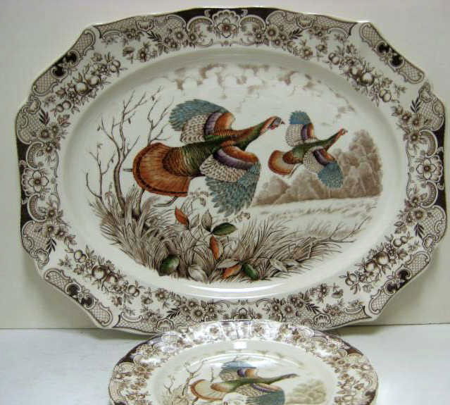 JOHNSON BROS, ENGLAND, WINDSOR WARE: Pottery game service flying "Wild Turkeys" pattern, brown transfer and hand colored, comprising platter (20 1/2 x 16) and 11 matching service plates (d. 10 1/2), 20th century.