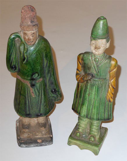 TWO CHINESE GLAZED EARTHENWARE FIGURES: Standing men with simple molded features, primarily green glazed, 19th century. Heights:9 7/8 in; 9 in.