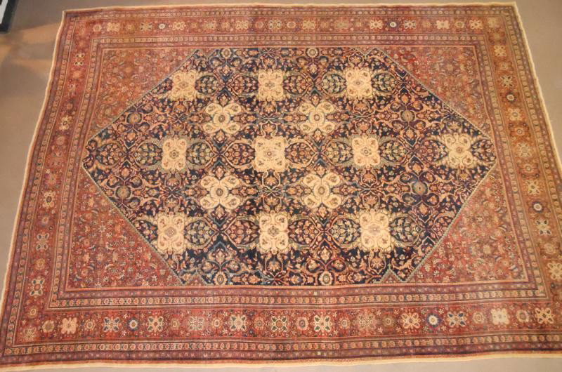 FARAHAN SAROUK ROOM RUG: Beige foliate medallions and flowering vines cover the navy field, red spandrels with matching primary border, multiple guard borders. 9 ft. 2 in. x 12 ft. 1 in.