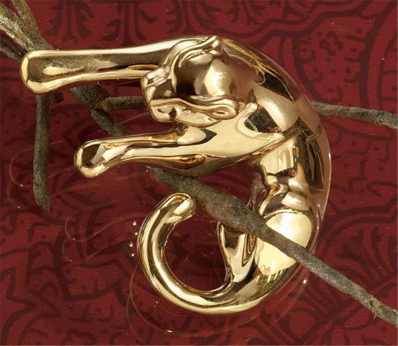GOLD PANTHER PENDANT: 14k yellow gold pendant with a high polished finish in the form of a resting panther. 1 5/8 x 1 1/4 inches. 3.5 grams.