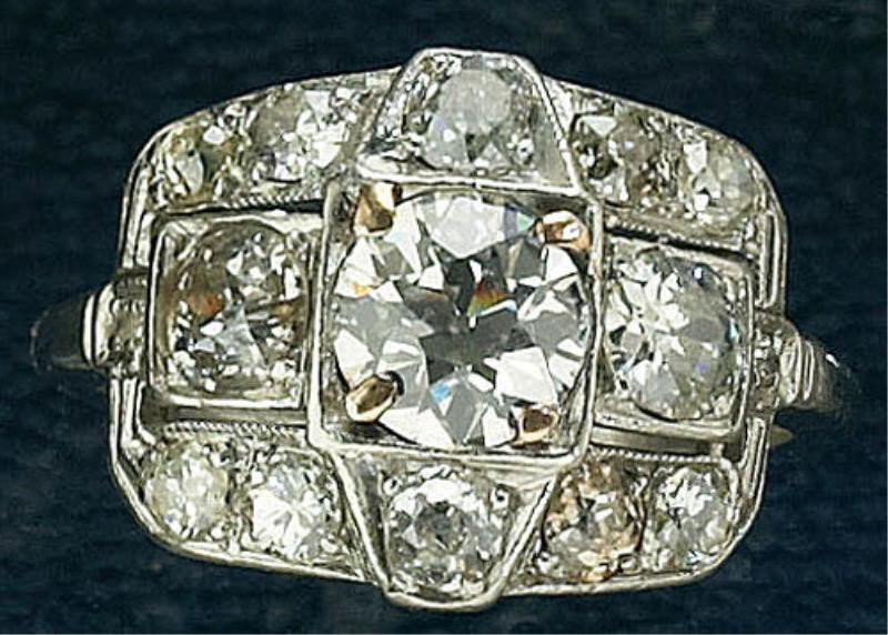 EDWARDIAN DIAMOND RING: Platinum ring set with one European cut diamond weighing .80ct. with fourteen mixed cut diamonds weighing 1.00ct.t.w. Size 5 3/4. 5 grams.