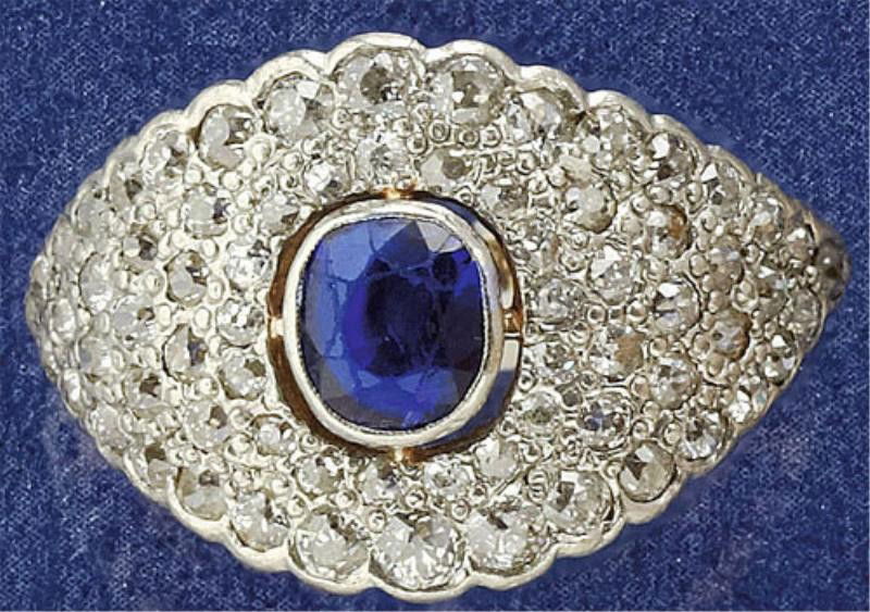 VICTORIAN SAPPHIRE AND DIAMOND RING: Platinum topped yellow gold ring with one bezel set cushion cut faceted sapphire measuring 6mm x 5.3mm with sixty-eight European cut diamonds weighing 1.40ct.t.w. Size 8.