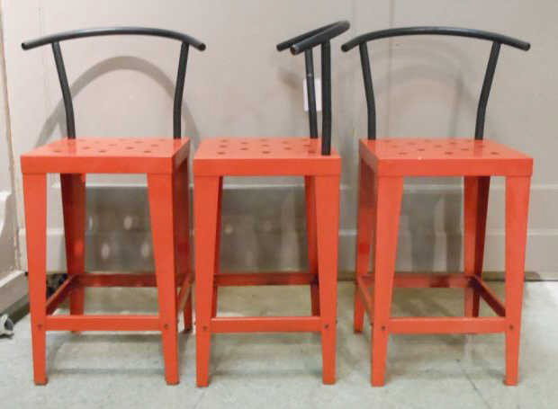 THREE MEMPHIS STYLE BAR STOOLS: Red and black painted sheet metal with tubular backrests. 40 inches (overall) 26 1/2 inches (seat height)