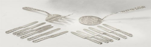 S. KIRK & SON and JENKINS & JENKINS, INC.: Sterling silver flatware with floral repousse handles including 12 Kirk's butter knives (5 1/16") and Jenkins & Jenkins tomato and bacon servers (8 1/4"; 8"), monogrammed. Total weight 15 troy ounces.