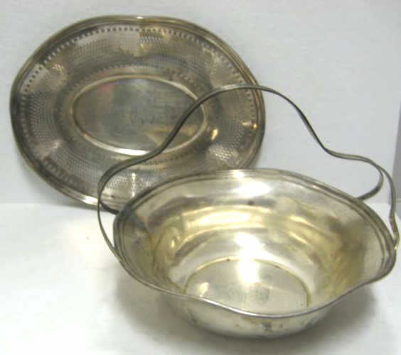 GEORGE A. HENCKEL & CO, NEW YORK, NY: Two sterling silver table articles, a basket with strap handle, #1673 A (h: 7 1/2") and oval pierced bread tray #2043 (10 5/8 x 8 1/4 in), early 20th century. Weight 19.4 troy ounces.
