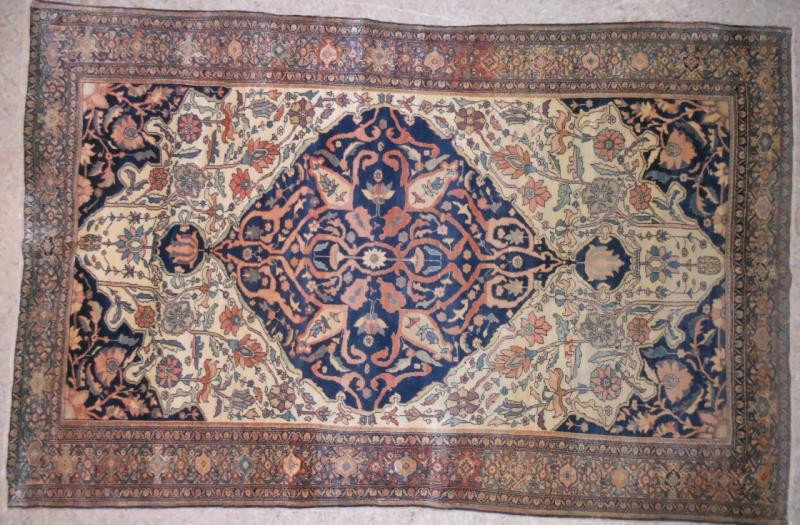 FINE ANTIQUE FARAHAN SAROUK AREA RUG: Scrolling foliate design, the large navy pole medallion and matching spandrels around the floral decorated ivory field, busy floral border with guard borders, circa 1900. 4 ft. 3 in. x 6 ft. 6 in.