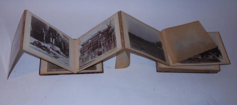 CHINA BOXER REBELLION PHOTO ALBUM: The paint decorated red lacquered cover opening to reveal 50 4" x 5 1/2" photographs of Peking including executions, handwritten inscription to front leaf "with best wishes from Robert Marsden? Peking