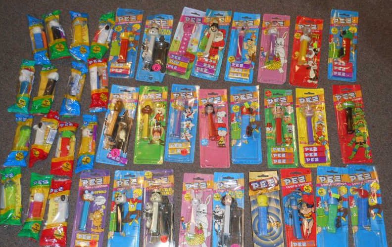 COLLECTION OF CARTONED AND BAGGED PEZ DISPENSERS: 1990's-1980's, stamped prices ranging .49-$1.29.