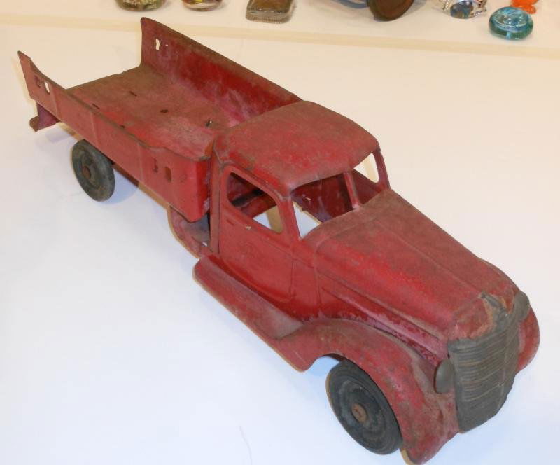 BUDDY L TOY LADDER TRUCK: Red, side panels of open bed impressed "LADDER TRUCK", doors impressed with company name, 21 3/4 in.