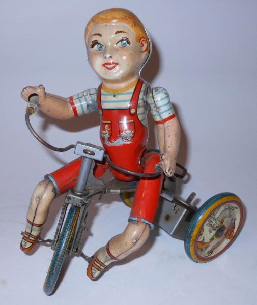 UNIQUE ART KIDDY CYCLIST WIND UP TOY: tin lithographed, including all wheels, operational, some minor wear.