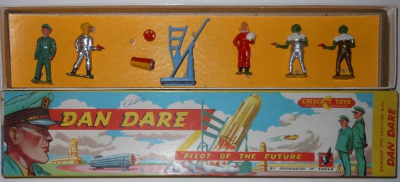 RARE ENGLISH CRESCENT DAN DARE SET: Rarely seen, includes Dan Dare in military uniform, Dan Dare in space suit, two part rocket and rocket launcher, Miss Peabody, and two Treen figures (one in gold suit, the other in silver suit). In ve