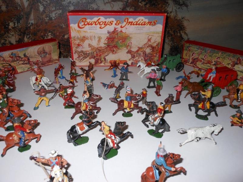 AMERICAN INDIAN AND COWBOY FIGURES: A large collection, most in battle poses, many mounted on horses, some shooting guns and bows, guitar player, man tied to tree, two stage coaches and more. Manufacturers include Crescent, Timpo and ot