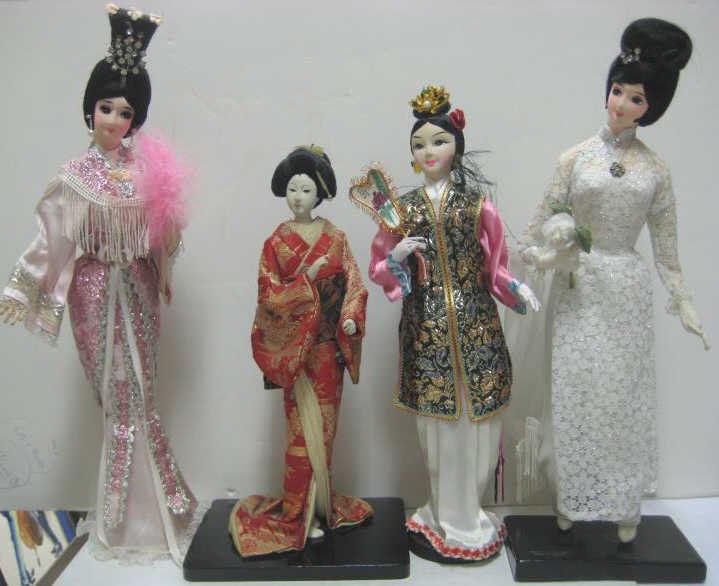 FOUR ASIAN DOLLS: 13" Japanese composition Geisha with inset glass eyes and three all-fabric Vietnamese fashion dolls with painted features.