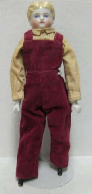 14" GERMAN CHINA SHOULDER HEAD BOY DOLL: Blond molded hair, painted blue eyes, cloth body with china hands and boots, wearing shirt and overalls.