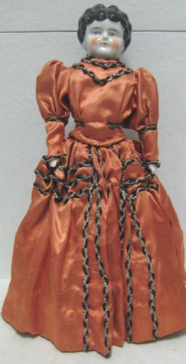 15" GERMAN CHINA SHOULDER HEAD DOLL: Black 'low-brow' hairdo, blue eyes, mold #3, cloth body, china arms, sewn-on boots, brick red silk dress.