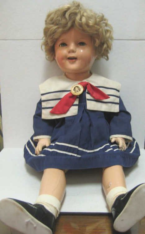 27" IDEAL 'SHIRLEY TEMPLE' COMPOSITION DOLL: Early version, marked on head 'Shirley Temple / Cop Ideal N&T, unmarked body (imperfections), wearing sailor style dress and original pin button.