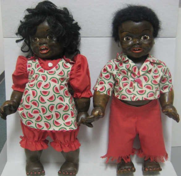 16" PAIR OF PATTI HALE WOODEN BLACK DOLLS: A wigged girl and boy toddlers, wide open eyes and mouth with two upper teeth, painted details on stained wood, jointed at necks, shoulders and hips, incised signatures and mold numbers.