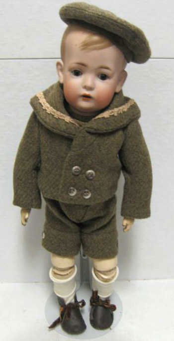 16" BRUNO SCHMIDT 'TOMMY TRUCKER' DOLL, #2096: Bisque solid dome head, molded and painted hair, set glass eyes, open mouth with two upper teeth, jointed composition body, wearing brown jacket & shorts with matching cap, impressed heart mark and mo