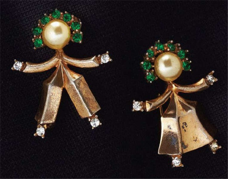 Trifari Brooch Pair: Vintage Trifari brooches depicting boy and girl dancers with green rhinestone crowns and white rhinestone hands and feet. 1 1/4 inches.