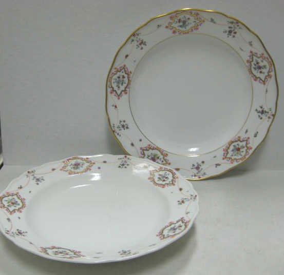 TWO MEISSEN PORCELAIN SOUP PLATES: Scalloped rims painted later with floral cartouches, one has gilt rim, 'Pommel Crossed Swords' marks, circa early 20th century. Diameter 9 1/2 in.