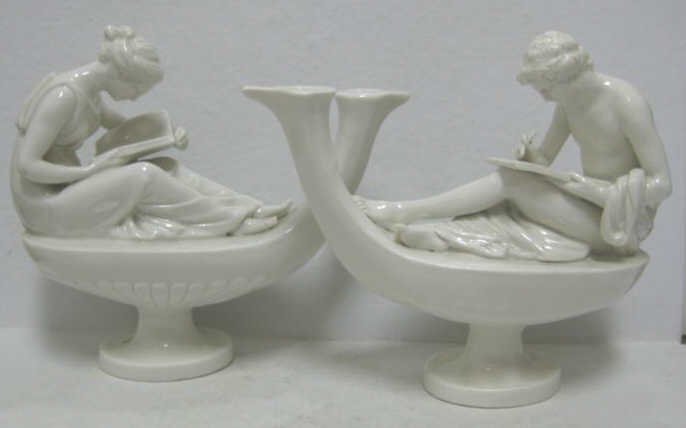 PAIR OF ITALIAN PORCELAIN FIGURAL GROUPS: Neoclassical style after Canova, each white glaze oil lamp form with figure seating on a top, female reading and man writing; pierced to be mounted as table lamps, marked, 20th century. Height 7 3/8, 