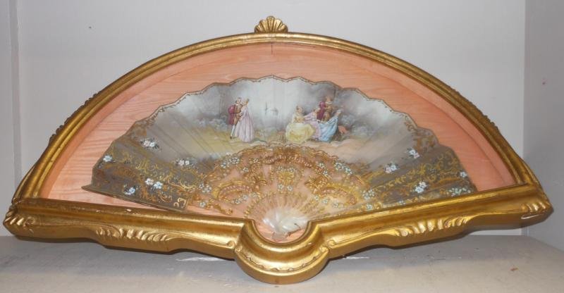 CONTINENTAL PAINTED HAND FAN: Each side painted, leaf with outdoor courtyard scene with figures, signed and rivet with garden landscape, supported on sixteen pierced, enamel and gilded plastic sticks and two guardsticks, mounted i