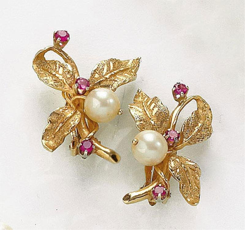 PEARL AND RUBY EARRINGS: 14k yellow gold floral screw-back earrings each featuring a 7.2mm pearl and three 3mm faceted rubies. 1 1/4 inches. 9.3 grams.