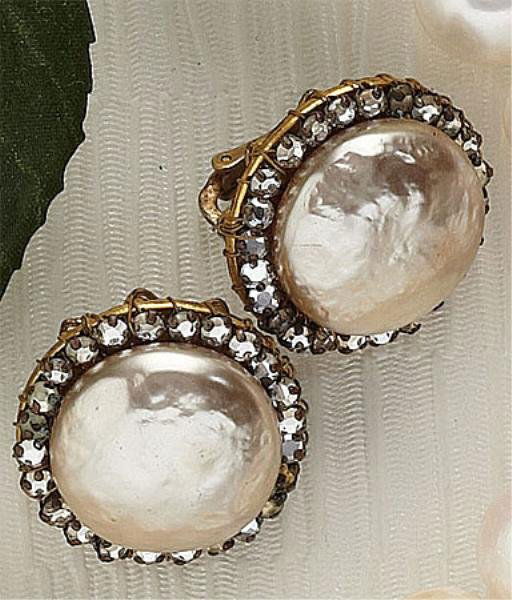 CLIP EARRINGS, MIRIAM HASKELL: Button style earrings featuring a large faux baroque pearl surrounded by rhinestones. 7/8 inch diameter.