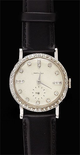 DIAMOND WATCH MAN'S HAMILTON: 14k white gold vintage Hamilton watch with a round white dial with fifteen diamond markers, and inset second hand dial. Bezel is set with forty single cut diamonds weighing .50ct.t.w. Watch has a Coac