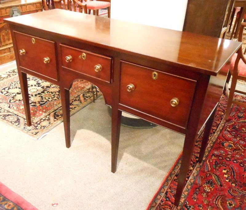 MAHOGANY HEPPLEWHITE STYLE SIDEBOARD: By KITTINGER, with plain rectangular top over three drawers, on tapering square legs. Height 36, width 57, depth 20 1/4 in.