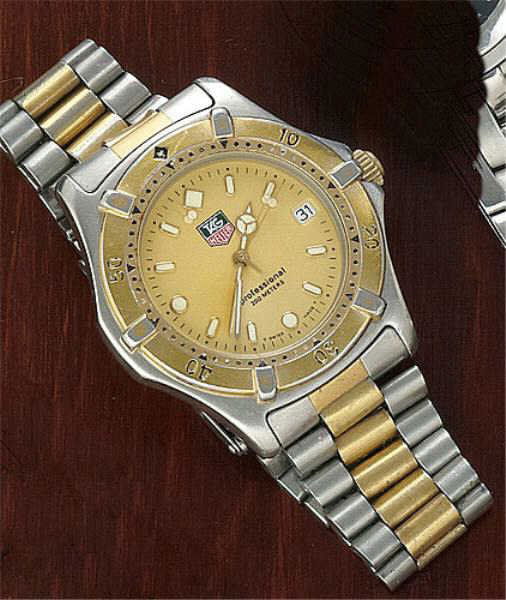 WATCH, TAG HEUER: Stainless steel watch with gold color dial and three hand quartz movement. Watch has gold and stainless moveable bezel and two tone bracelet. 6 3/4 inches.