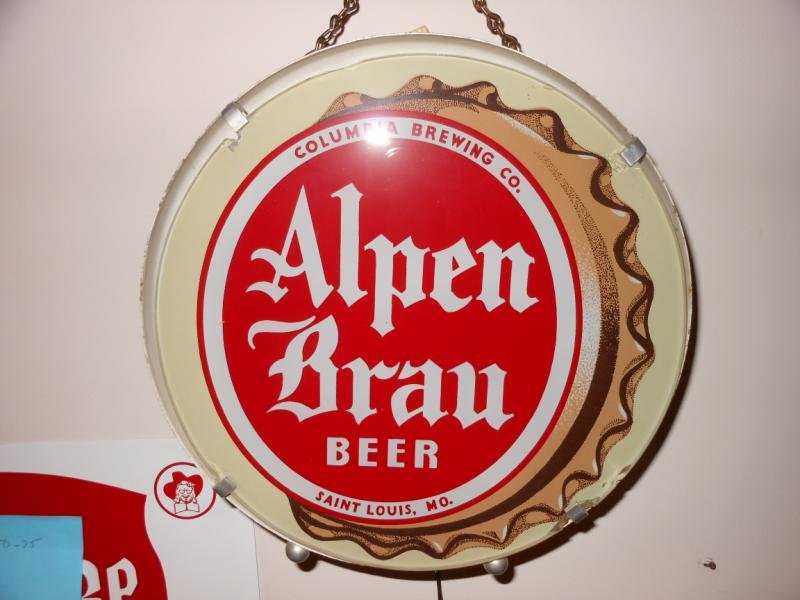 "ALPEN BRAU" BEER LIGHT: Circular with inset glass front showing a reverse painted bottle cap, glass diameter 10 1/2 in., working. Henry Herbst Collection