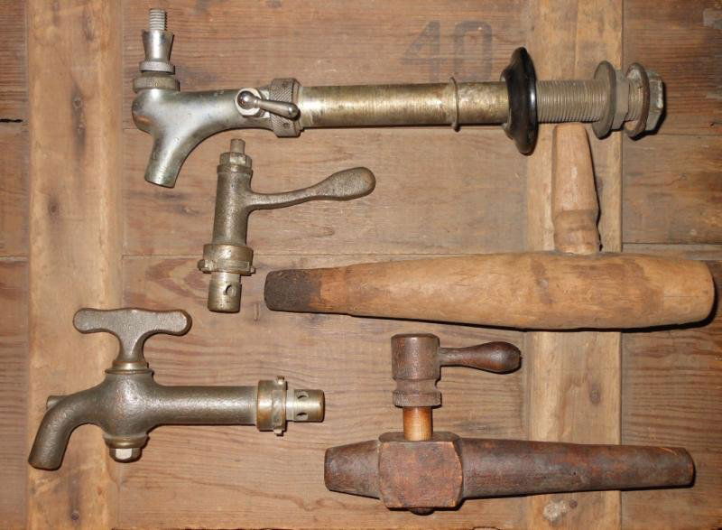 FIVE VINTAGE BEER TAPS: Two wooden and three heavy metal. Henry Herbst Collection