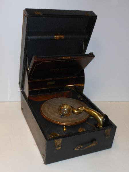 COLUMBIA GRAPHONOLA MODEL 162 RECORD PLAYER: Interior of lid with mahogany drop down record storage, crank mounted to exterior front panel, all within the black leatherette carrying case.