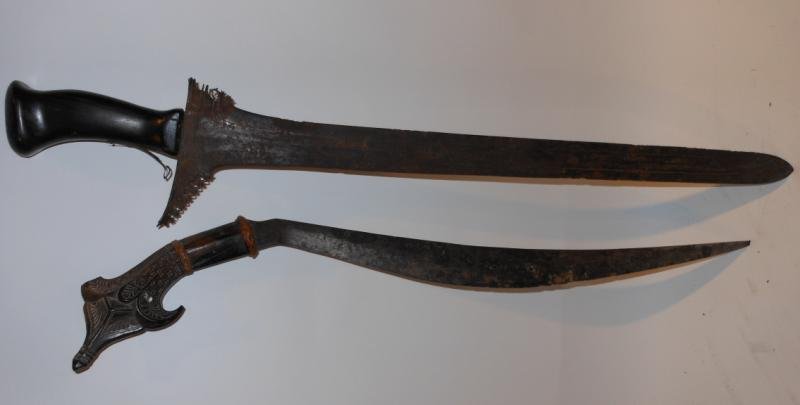 TWO SOUTHEAST ASIAN EDGED WEAPONS: Malay Keris having straight fullered 24 1/2 inch blade , (replaced handle, loss of scabbard, severe rust to blade) together with a Northern Philippine's Talibon with 21 1/4 inch blade, carved hilt wit