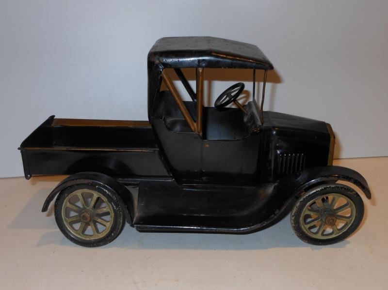 PRESSED STEEL TOY VEHICLE: Model T, black with gold highlights, all metal spoked wheels, length 12 1/4 in.