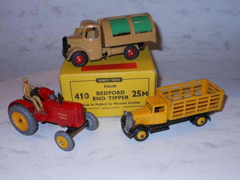 DINKY TOYS AND BOX: Three vehicles, all in very good condition, including the Bedford Refuse wagon with operational crank, beige body and green working doors, "Massey Harris" tractor in red, a yellow stake bed truck with