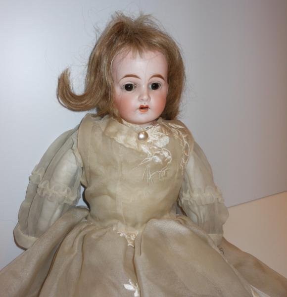 23" CUNO & OTTO DRESSEL CHILD DOLL: Bisque shoulder-head on kid body (imp), bisque arms, hairline crack on a shoulder plate.