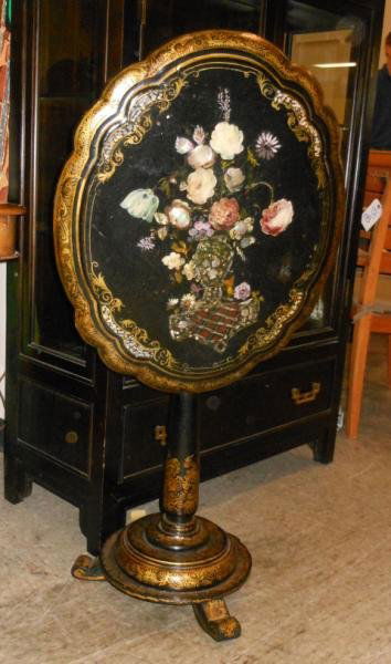 ENGLISH 19TH CENTURY PAPIER MACHE TILT TOP TABLE: Shaped top, centering a hand painted and mother-of-pearl inlaid floral bouquet, on columnar pedestal support with gilt highlighted circular three footed base. Height 28, width 21, depth 25 1/2 in.