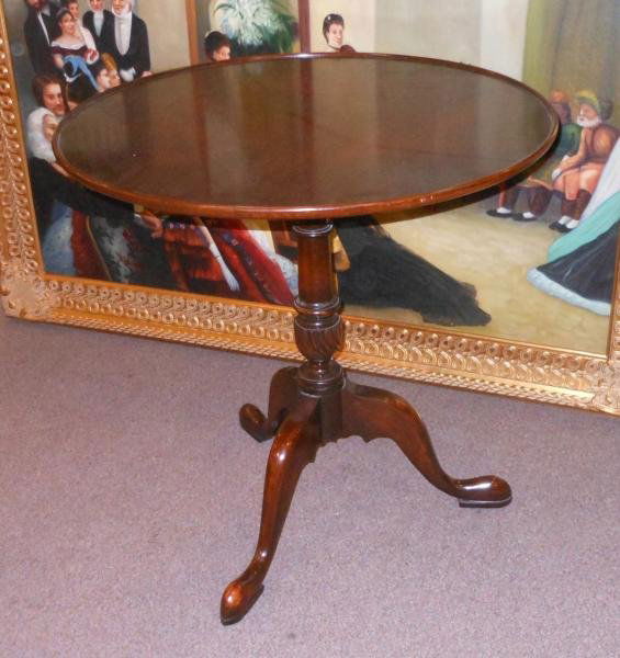 GEORGIAN STYLE MAHOGANY TILT TOP TEA TABLE: Circular dished top, on bird cage mechanism and tapering turned pedestal support, on three slipper feet. Height 26 1/2, diameter 27 in.