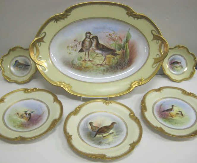 ANTIQUE FRENCH PORCELAIN GAME BIRD SERVICE: Delinieres porcelain serving tray (16 1/2 x 13 in), eleven plates (9 1/8 in.) and two sweetmeat dishes, each gilt scalloped rimed, yellow grounded painted with bird scenes at L. Bernardaud & Cie, Limo