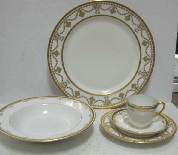 FRENCH LIMOGES PORCELAIN TABLEWARE: Gold decorated associated service for twelve comprising Haviland dinner and bread/butter plates and Bernardaud & Co. soup/dessert plates, demitasse cups and saucers, early 20th century, total 60 piece