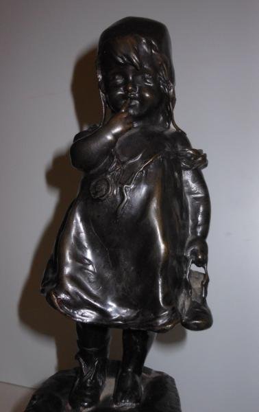 JUAN CLARA, SPANISH (1875-1958): Bronze figure of a young girl standing on a stool holding a finger to her mouth, her shoe in other hand, signed, with "LB" and "347" to back side of stool. Height 12 7/8 in.