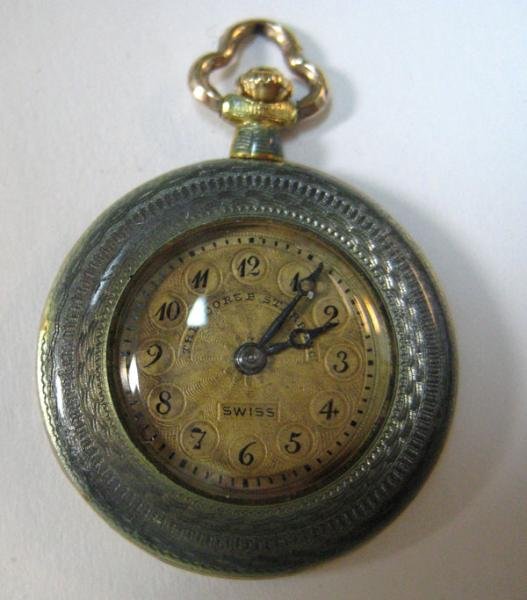 DIAMOND PENDANT WATCH: 18k yellow gold Theodore B. Starr Inc. pendant watch with blue guilloche design (some losses). Watch has an 18 jewel Jules Robert Swiss manual movement. Back of the watch has attached platinum filigre