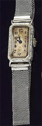 LADY'S WRISTWATCH, LONGINES: 18k white gold tank watch with engraved case and manual-wind Longines movement (not running). Watch has an 18k white gold fine mesh bracelet with adjustable length. Weight without movement or crystal,