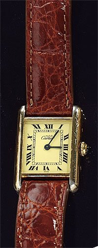 TANK WATCH, CARTIER: Cartier tank watch with Vermeil-over-sterling case, quartz movement and Roman numeral markers. Watch has brown leather strap. Back reads "Cartier Paris Vermeil Tank Quartz Argent 925 Plaque OR G 20M S