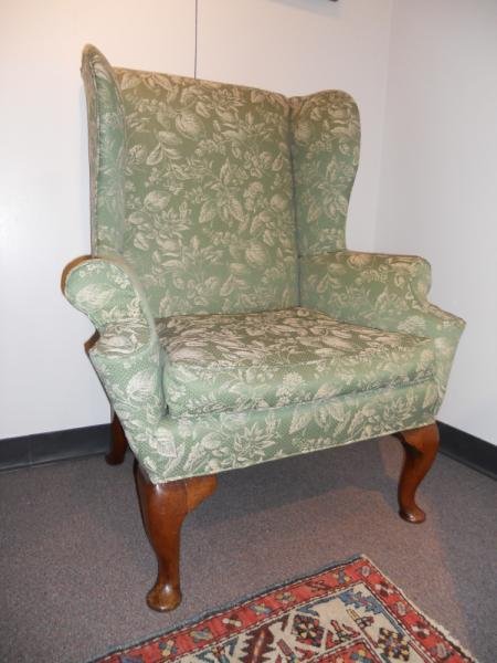 ANTIQUE ENGLISH WINGBACK ARMCHAIR: Outward lying arm rests, on thick cabriole front legs with pad feet, similar back feet, all with large caster holes. Height 43 1/2, width 36 1/2 in.